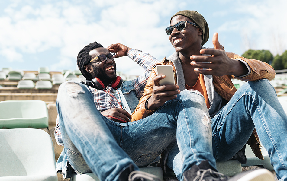 Two black race friends having fun with mobile. Friends Concept